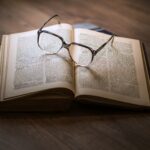 framed eyeglasses on top open book